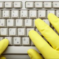 gloved hands on keyboard