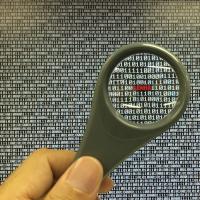 magnifying glass looking at code