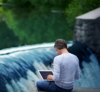 man working near waterfall