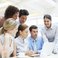 Team grouped around a computer