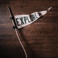 White flag that says "EXPLORE," photo by Andrew Neel