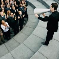 Manager with megaphone communicating with employees