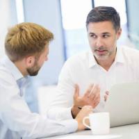 Man delivering bad news to a coworker