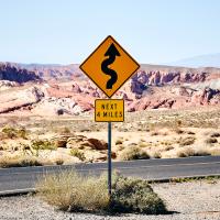 Sign indicating twisting roads ahead