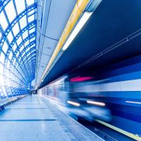 A train accelerating through a station