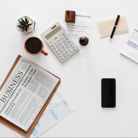 Productive person's desk with a phone, papers, and notes