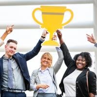 A high-performing QA team holding up a trophy