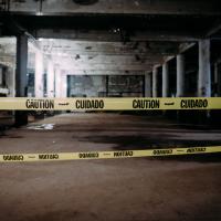 Caution tape stretching across a construction site