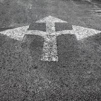 Asphalt with painted arrows pointing in three directions