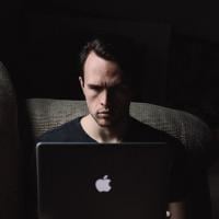 Unapproachable man scowling at his computer