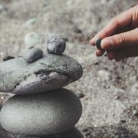 Person stacking rocks to build a foundation