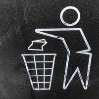 Icon of a person throwing garbage into a trash can