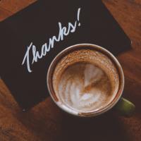 Thank-you card next to a cup of coffee