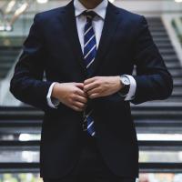 Executive buttoning his suit coat