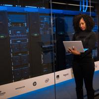 Engineer holding laptop in a data center