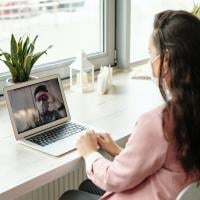 Two agile team members on a video call and wearing face masks