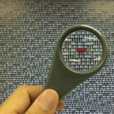 magnifying glass looking at code