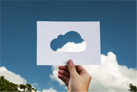 Person holding up a picture of a cloud