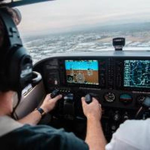 A cockpit's dashboards as a pilot flies a plane, photo by Kristopher Allison