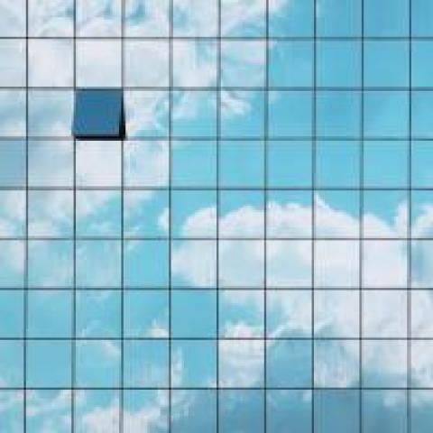 Building with clouds reflected on the side