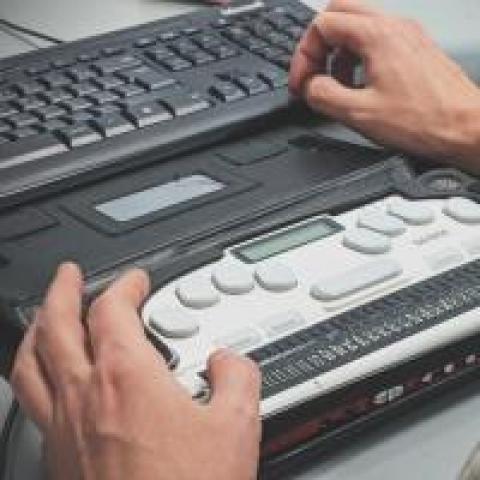 Blind person using a Braille screen reader