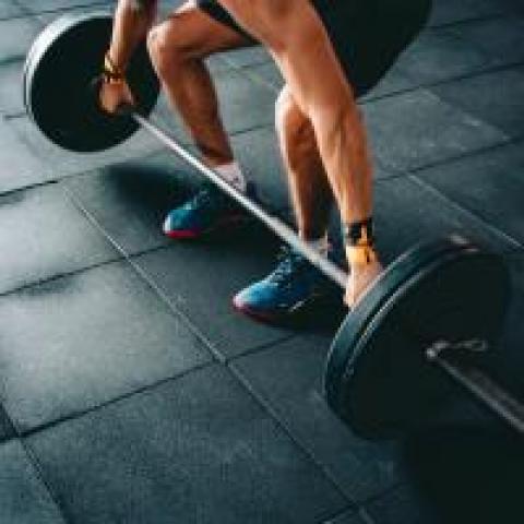 Man lifting barbell with heavy weights