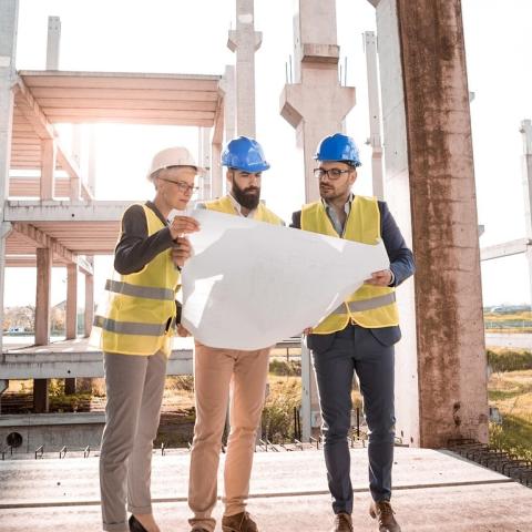 architects holding a blueprint