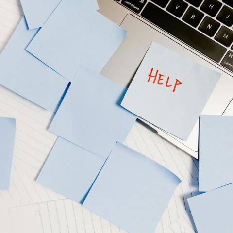 post-it notes scattered on a laptop