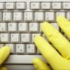 gloved hands on keyboard