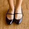 Woman's feet standing on a wood floor