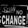 Sign in shop window that says "Sorry, no change"