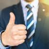 Tester in a business suit giving a thumbs-up