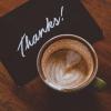 Thank-you card next to a cup of coffee
