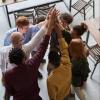 Scrum team high-fiving after their daily standup