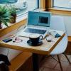 A remote employee's laptop open at a coffee shop