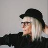 Stylish older woman with gray hair wearing a fedora