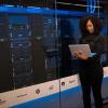 Engineer holding laptop in a data center
