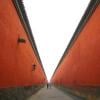 people walking between walls